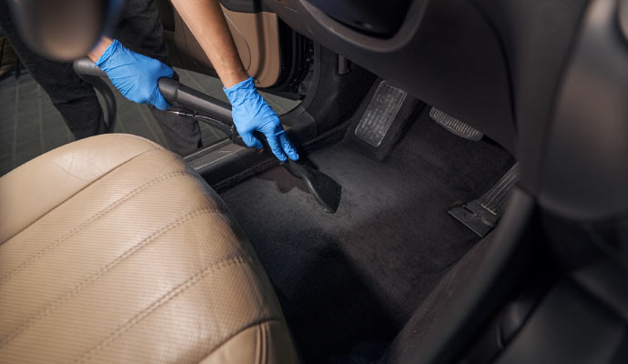 Professional worker cleaning car