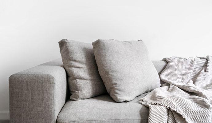 Clean minimalist grey couch with matching throw pillows