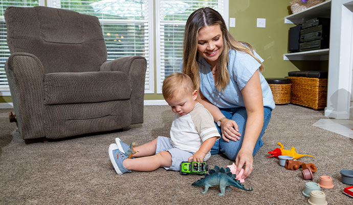 Mother and child playing on clean residential carpet.