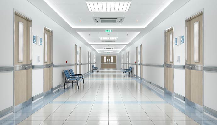 Clean hospital hallway with polished floors organized seating and bright modern healthcare environment