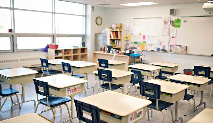Clean modern classroom with organized student desks, educational materials and bright learning environment