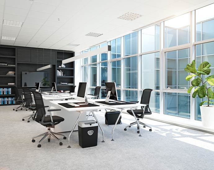 Clean modern office interior with organized desks bright lighting and professional workspace environment