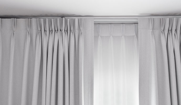 Light colored pleated cleaned drapery