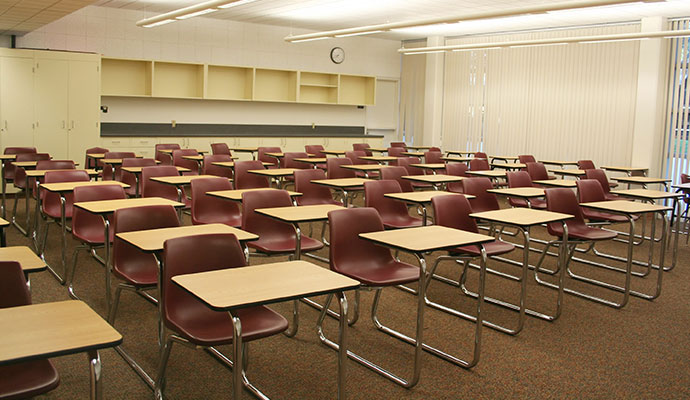 Clean classroom carpet with rows of desks