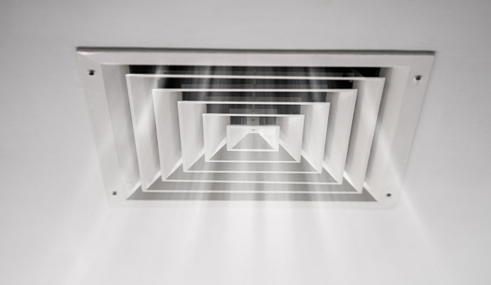 Ceiling air vent diffuser circulating fresh indoor air.