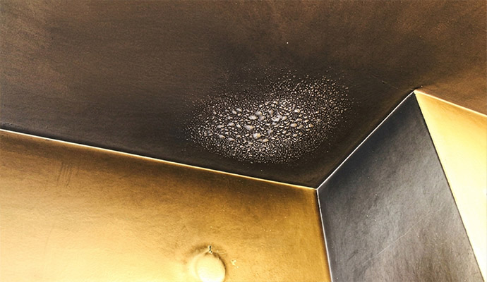 Heavy soot and smoke residue on ceiling and corner drywall.