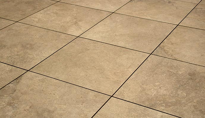 Dirty tile floor with dark grout lines