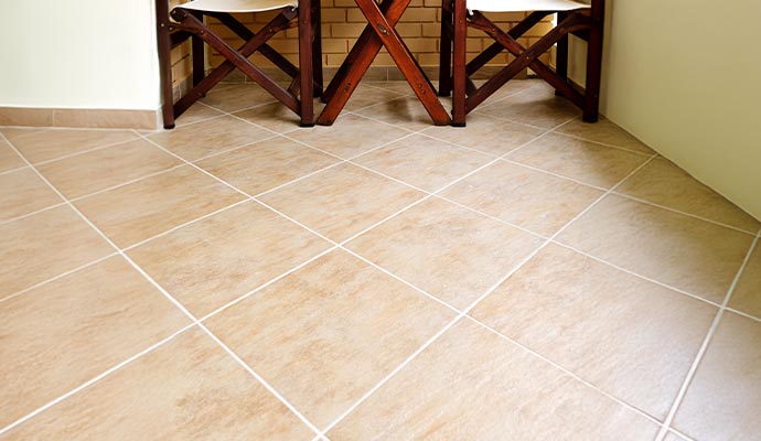Consistent, white colored grout lines on a tan ceramic tile floor
