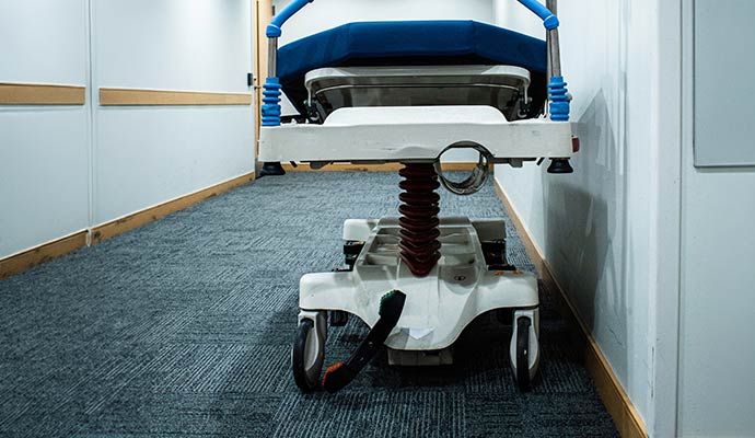Hospital hallway with clean carpet flooring and medical transport equipment in healthcare facility