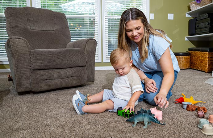 Spilled glass of red wine on carpet, creating a stain.
