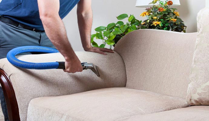 Professional worker removing odor from upholstery