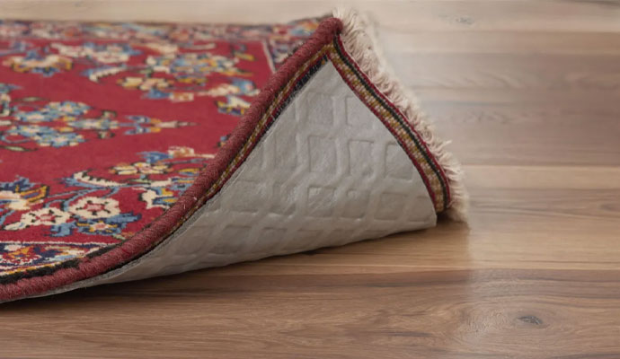 Protective rug pad under a red patterned area rug
