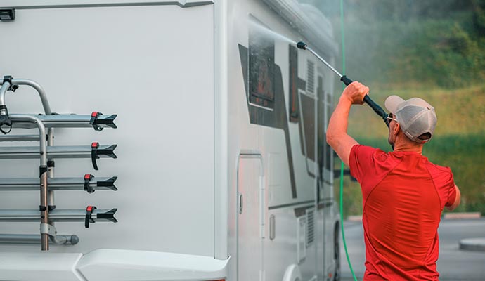 Professional worker cleaning RV