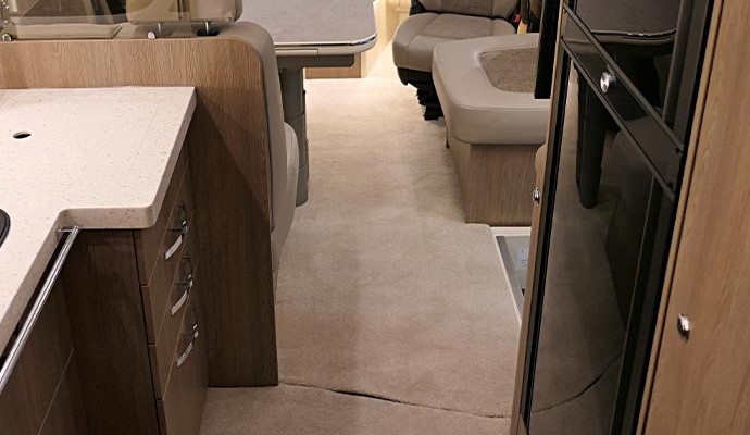 Spotless RV living space with polished surfaces and neat furniture.