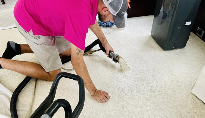 An expert cleaning carpet inside a yacht using professional tool