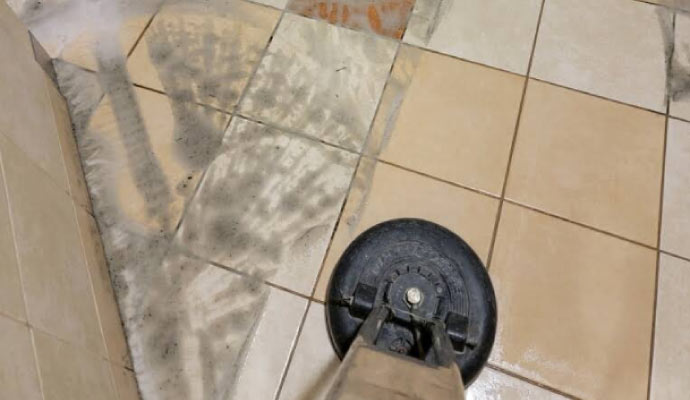 Professional worker cleaning stone floor