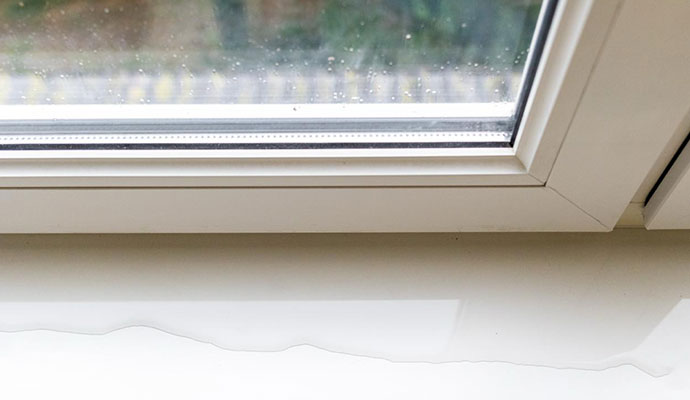 Water pooled on interior window sill
