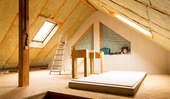 Professional worker restoring attic water damage