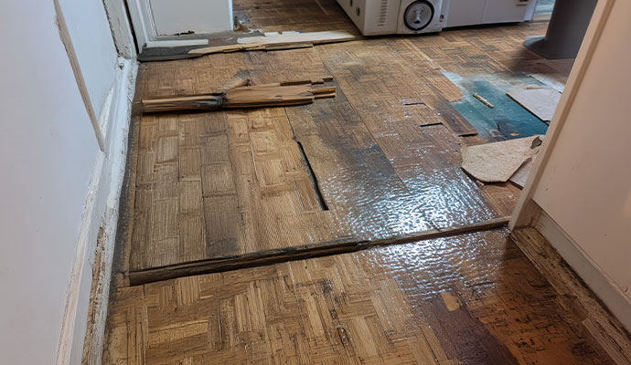 Warped and damaged wood flooring after a water leak.