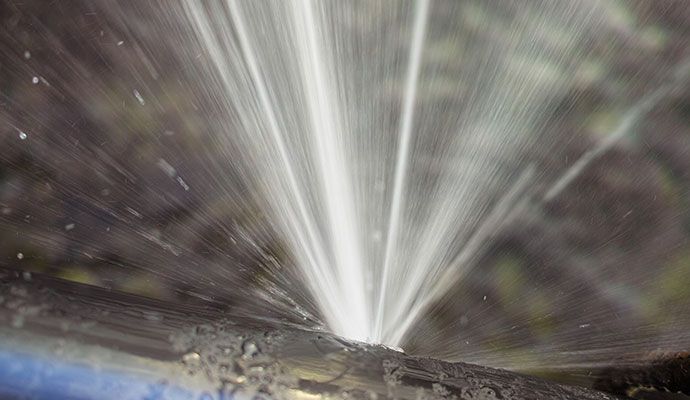 Broken water pipe spraying out water