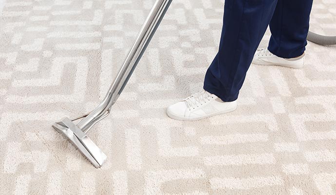 worker removing dirt chemical free carpet cleaning
